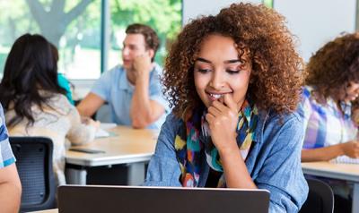 Young educator looking at her laptop